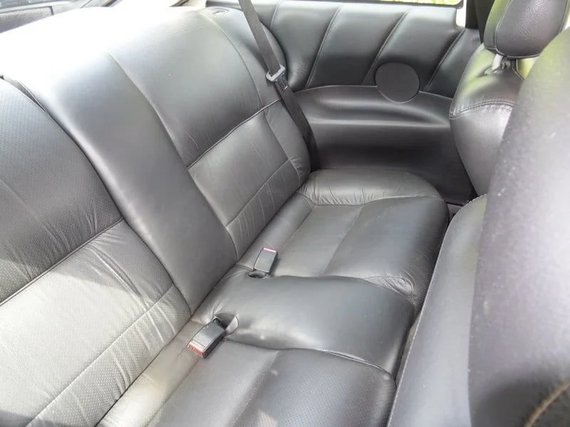 Black leather rear seats inside the Vauxhall Calibra wedding car