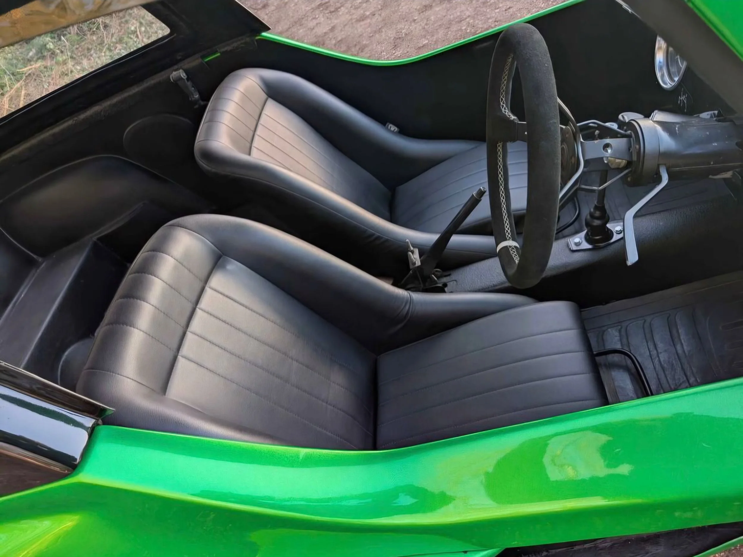 Black bucket seats inside The Hulk, our green VW beach buggy