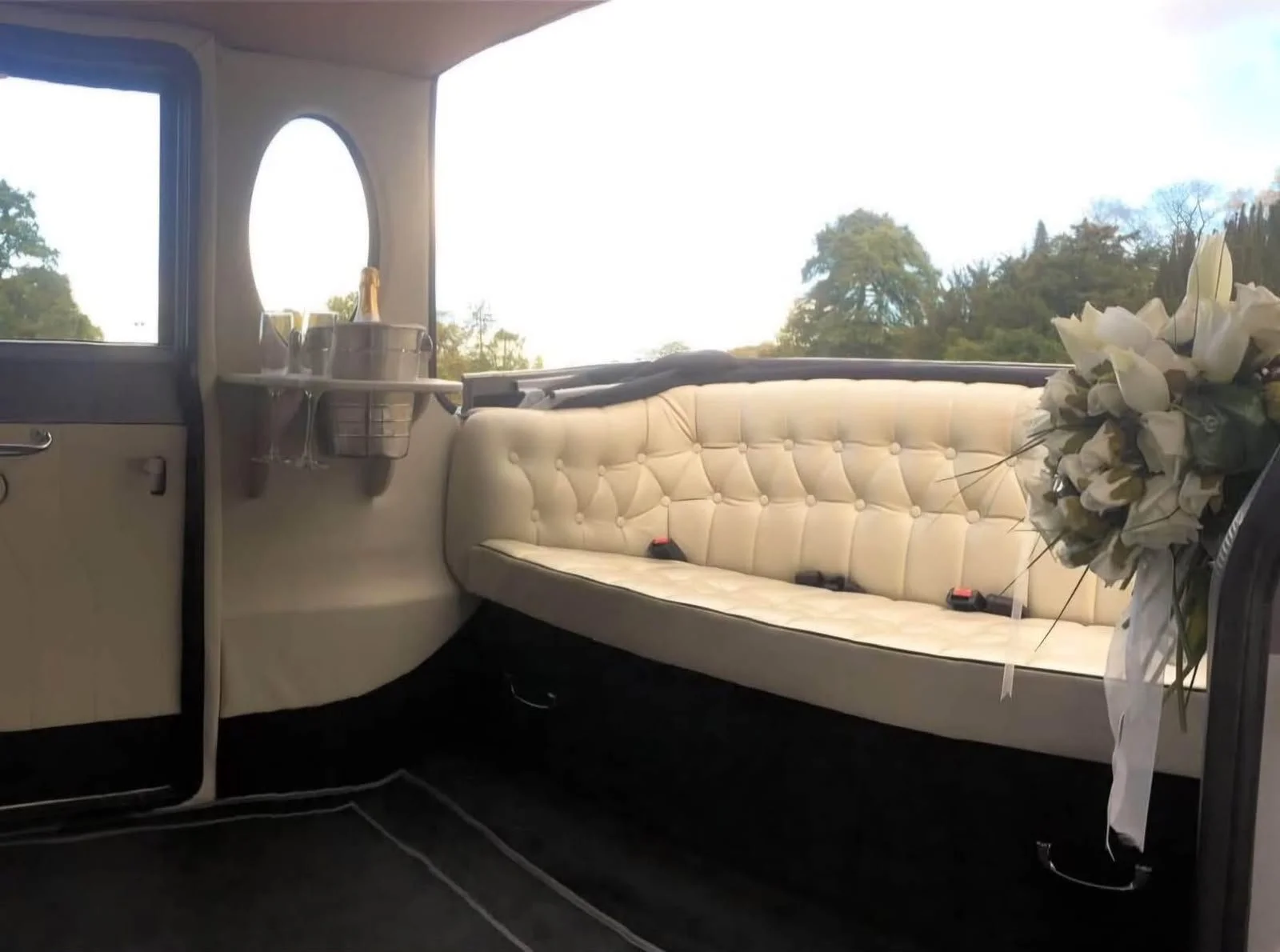 Cream button-back bench seat inside the Imperial 8-seater wedding car