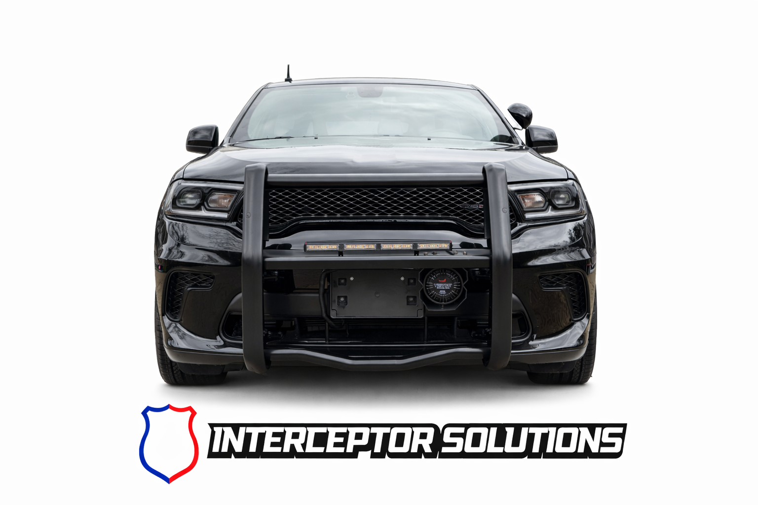 Black police car with a push bumper and light bar, branded 'Interceptor Solutions' with a shield logo.
