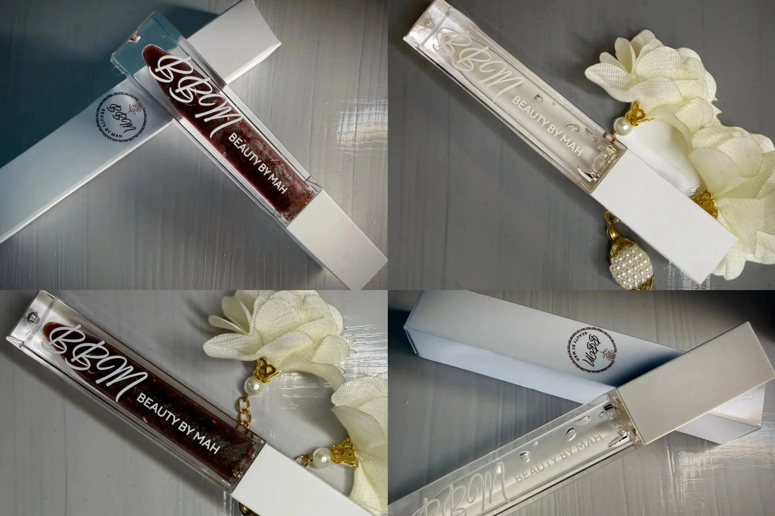 A clear rectangular lipstick tube with a white cap, holding dark red lipstick, labeled "BEAUTY BY MAH". The tube is decorated with a cream fabric flower and a pearl and gold charm. The image is shown from different angles on a metallic surface.