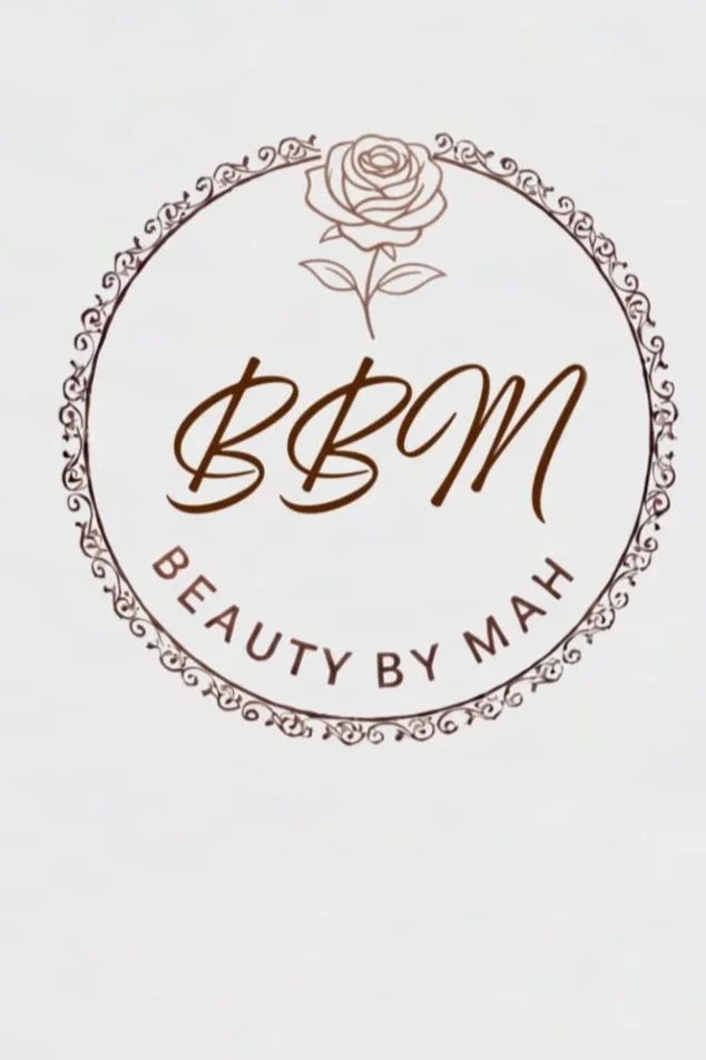 A logo for 'Beauty by Mah' featuring a rose at the top, surrounded by a decorative circular border, with the initials 'BBM' in the center and the full name surrounding the circle.