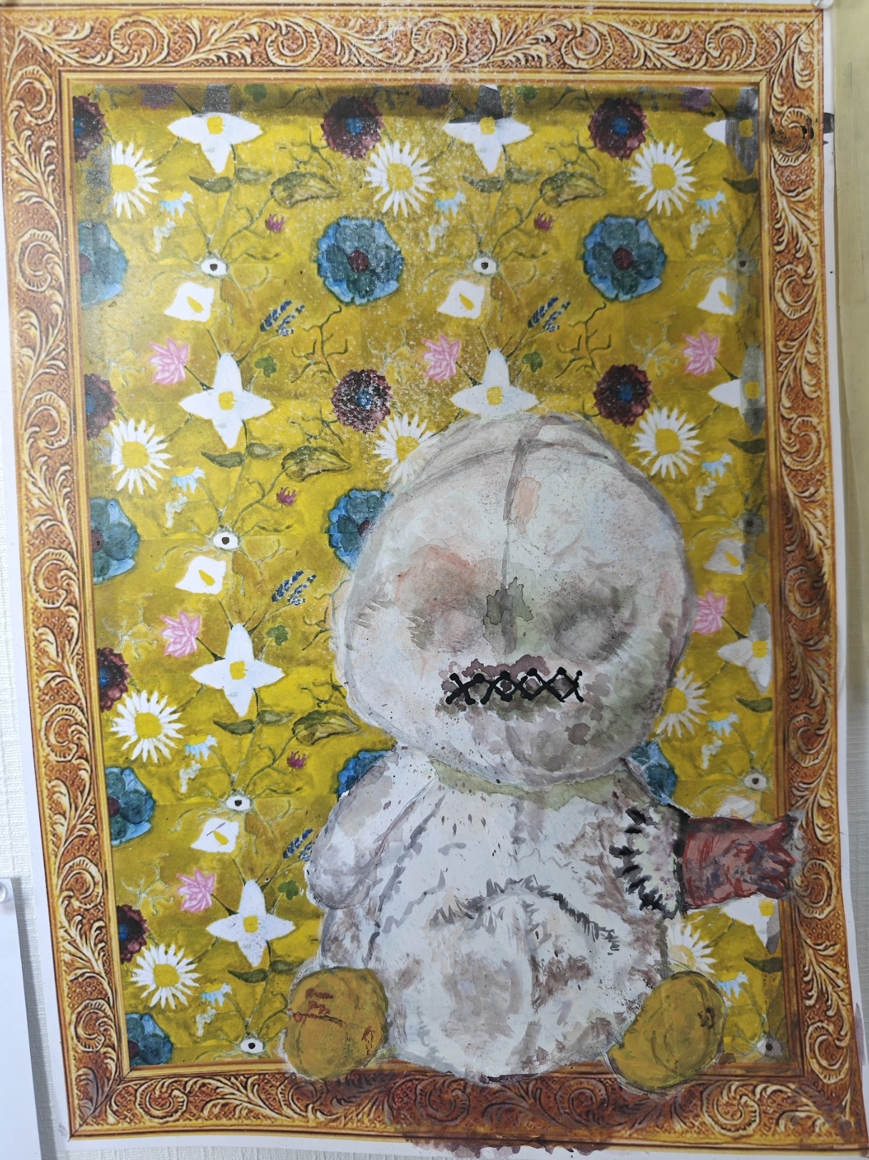 A children's artwork depicting a white stuffed animal with a large round head, sitting against a yellow floral background with white daisies, blue, pink, and red flowers. The stuffed animal has a stitched mouth, closed eyes, and yellow feet, with a brown paw visible on one arm. The image is framed by an ornate orange border.