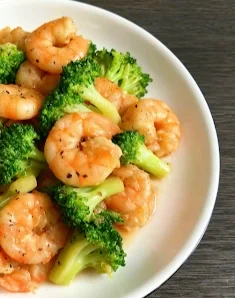 Shrimp and broccoli stir-fry on a white plate