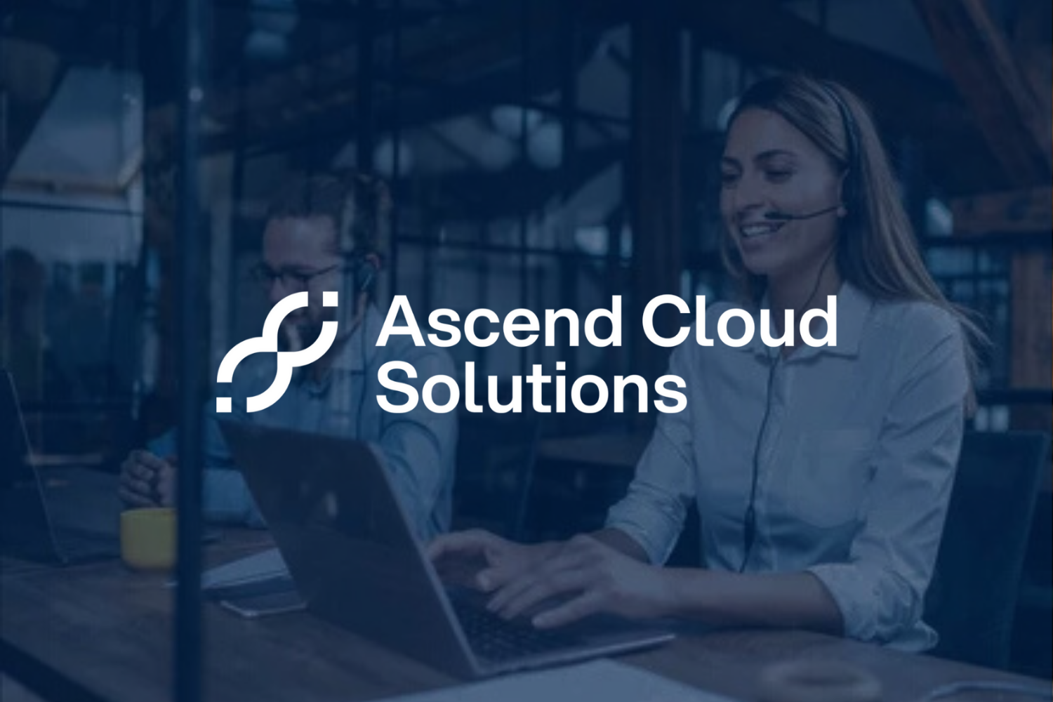 Business professionals working at a desk with a laptop, with the overlay text 'Ascend Cloud Solutions' and a logo.