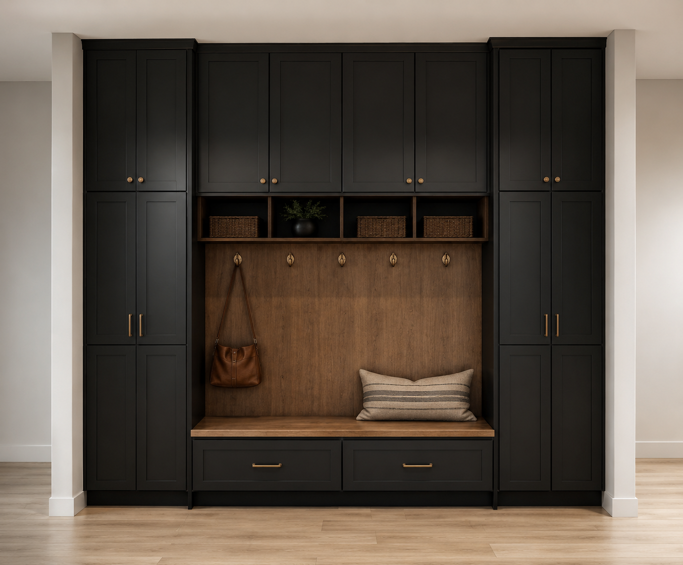 A built-in black and wood entryway mudroom with cabinets, shelves, hooks, a bench, and a cushion in a modern home. Custom designed by CJ Living Co.
