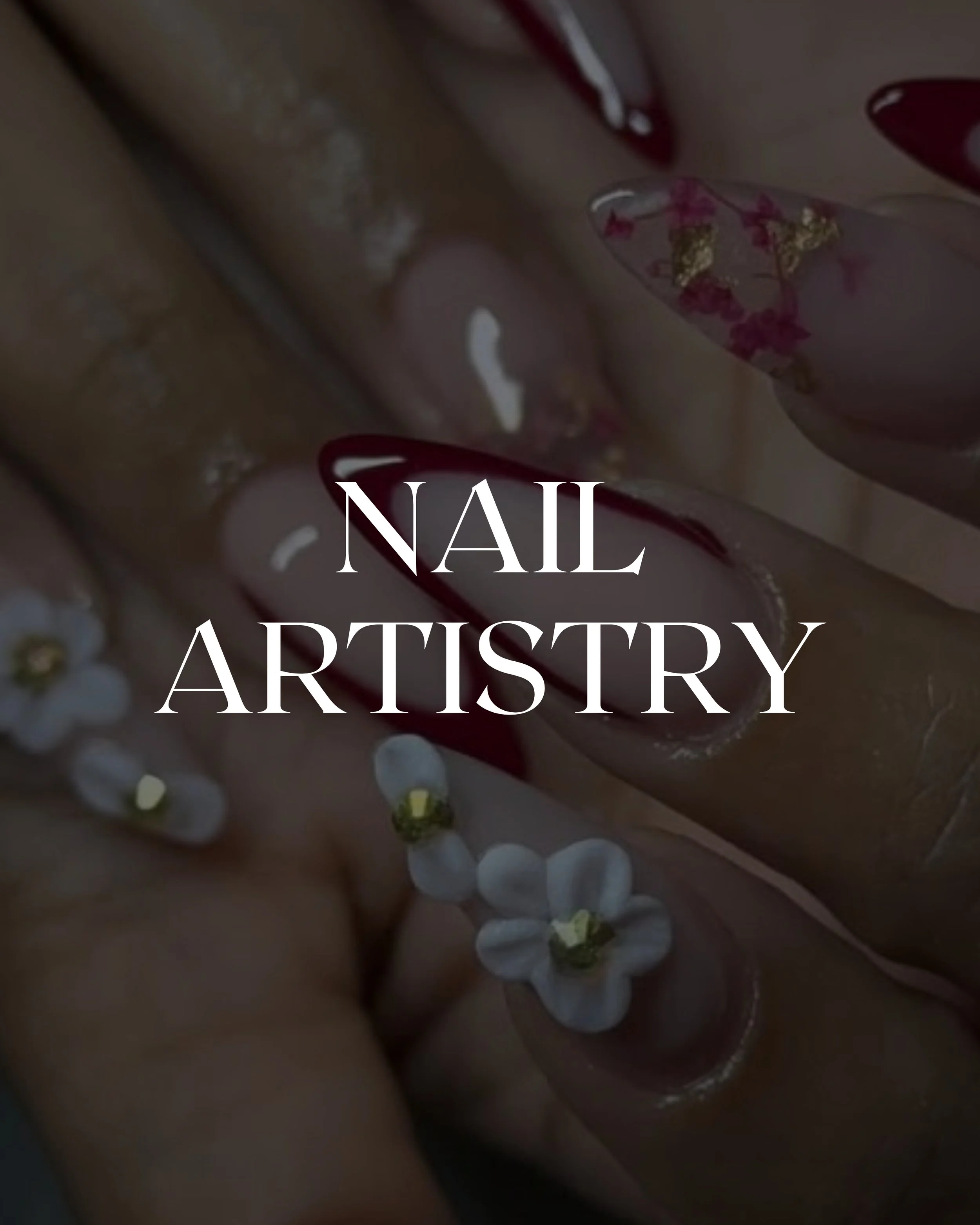 Close-up of neatly painted long nails with dark red and white design, some nails decorated with gold accents, and text overlay saying 'Nail Artistry'.
