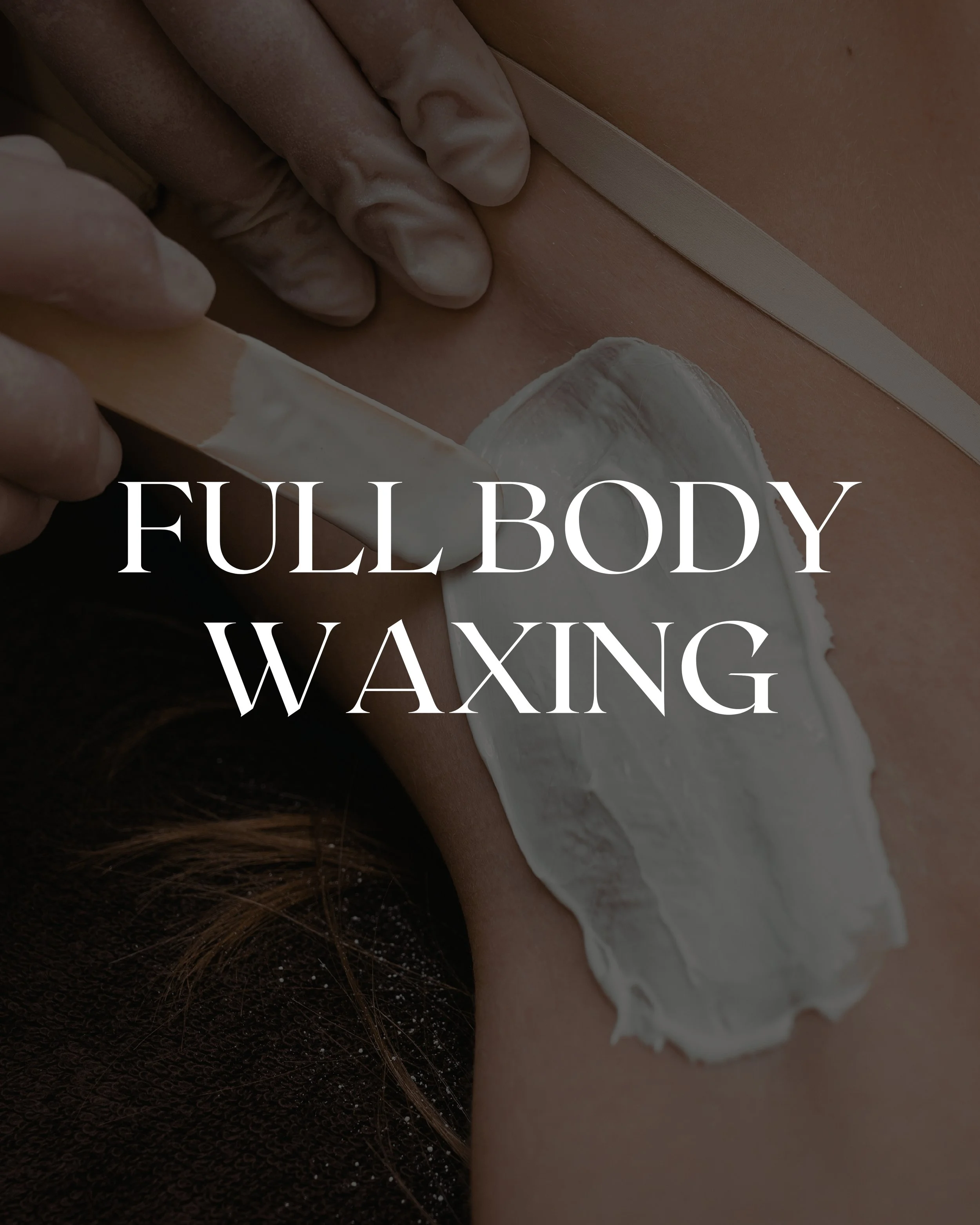 A person receiving full body waxing, with wax applied to their skin and a wooden spatula used to remove the wax.