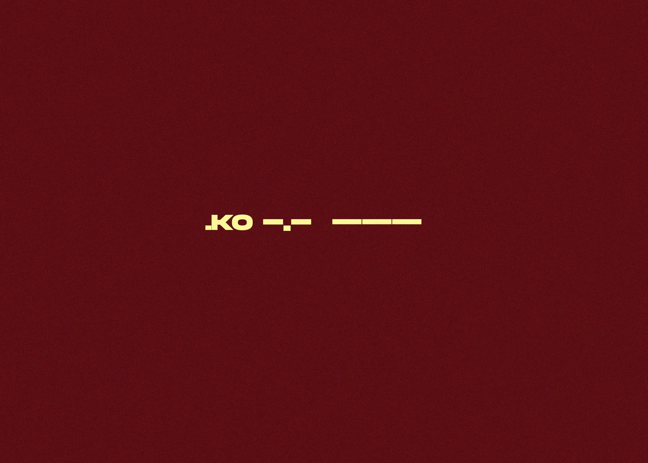A deep red background with yellow text that reads 'KO' and some lines.