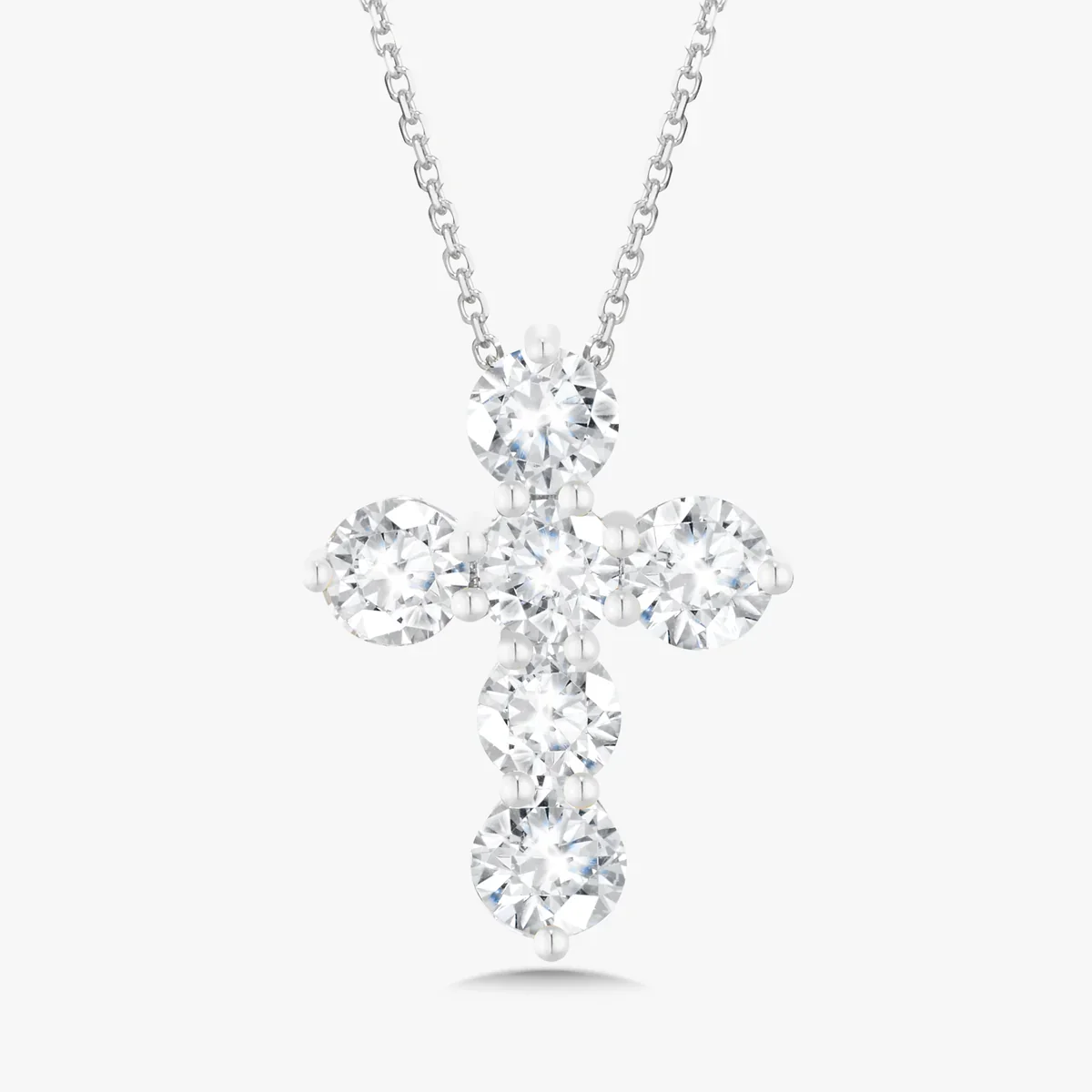 Silver chain necklace with a diamond cross pendant.