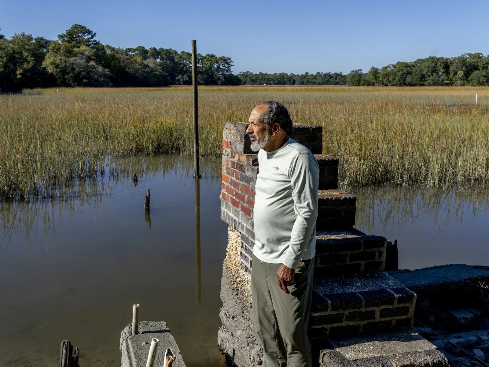 John Carr standing in front of the brick staircase in the marsh.