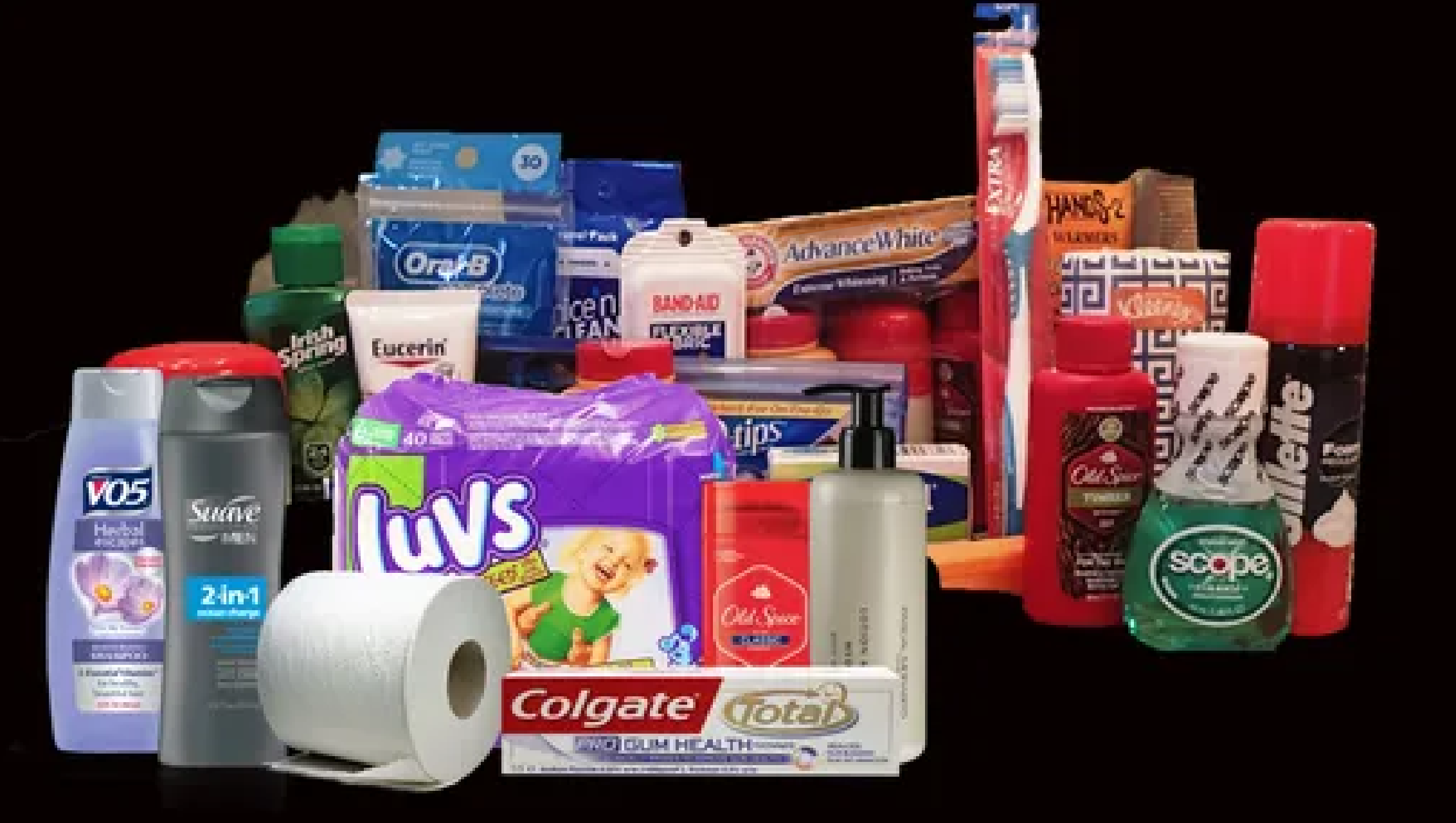 Collection of personal hygiene and household products including deodorants, toothpaste, toilet paper, shampoo, cleaning supplies, and laundry detergent on a black background.