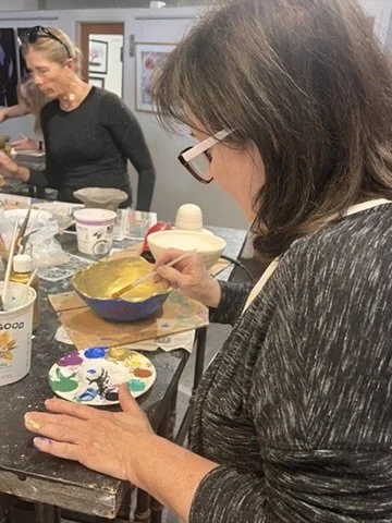 Women with paint palette at a group studio