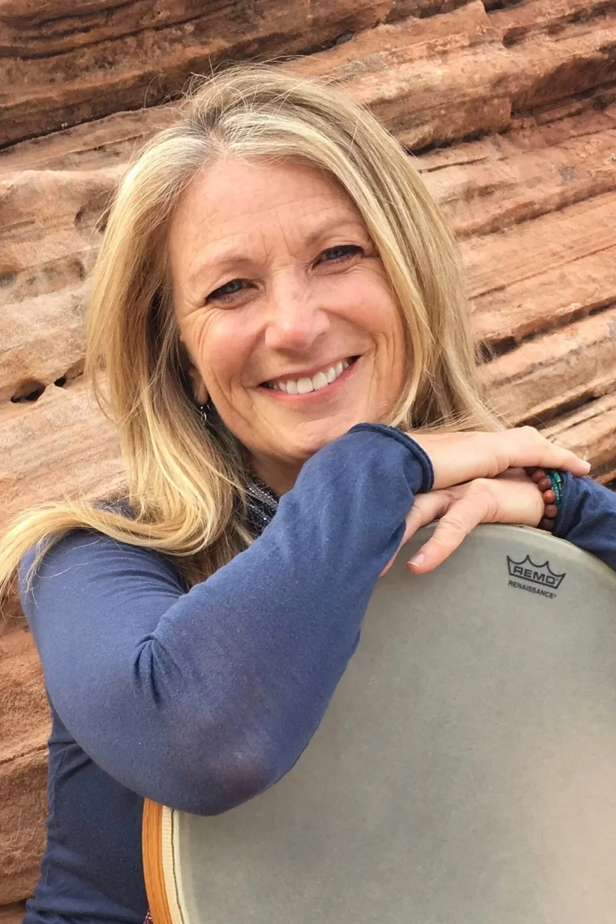 Headshot of Christine Stevens while leaning on her drum