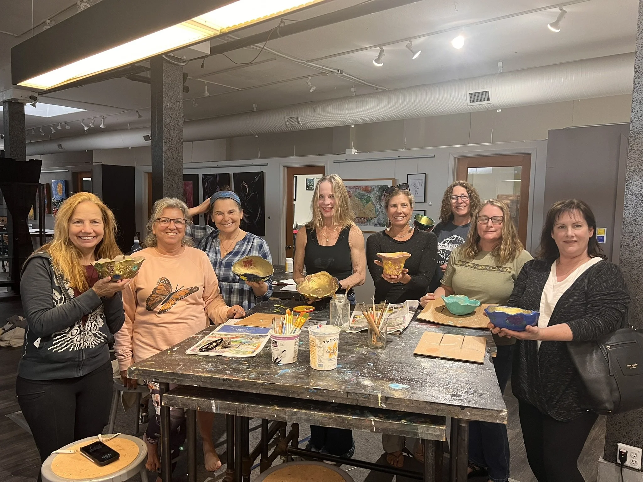 Group of women creating art during a workshop with Karen