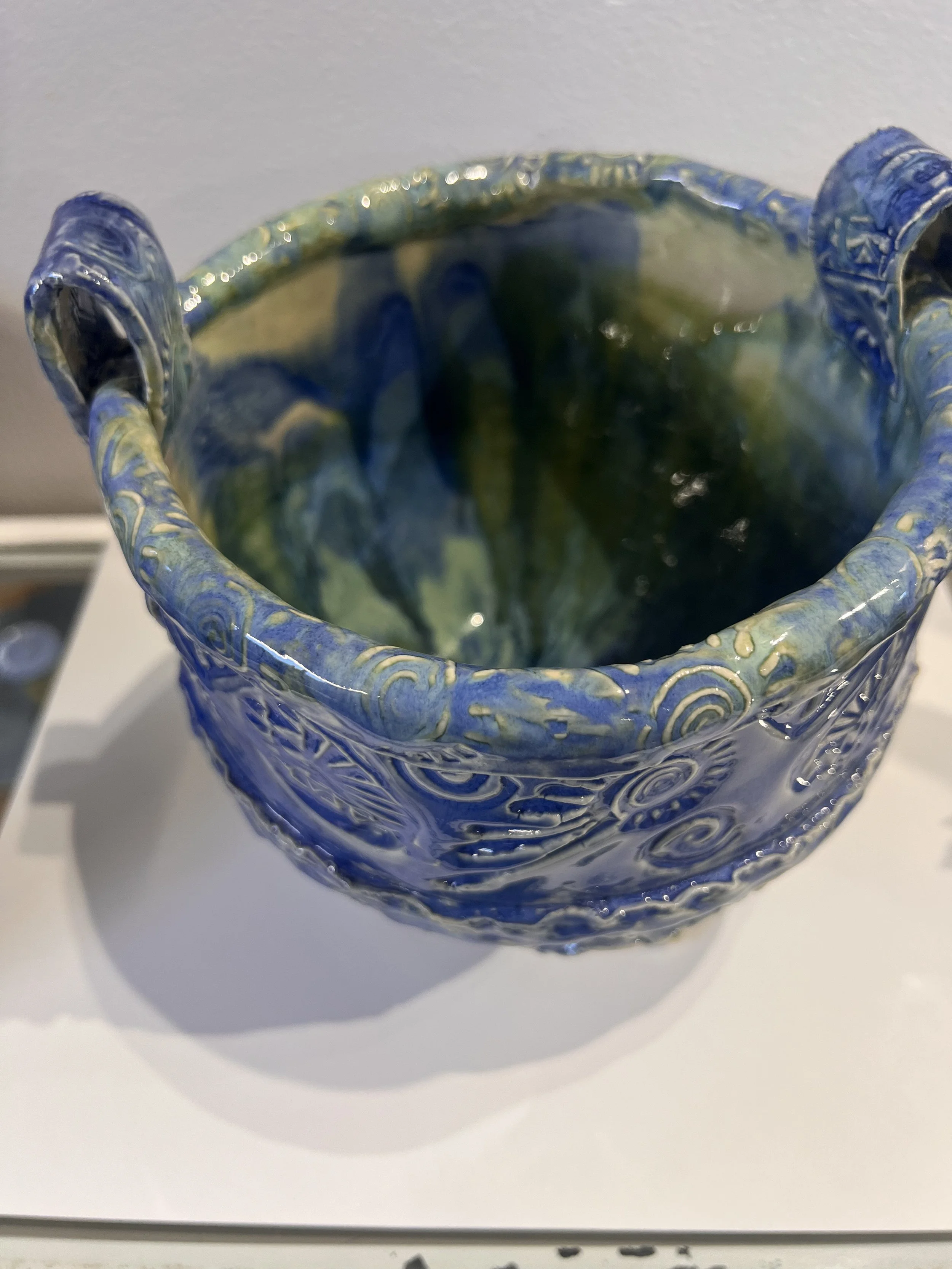 Interior of blue stoneware story bowl with glossy glaze, deep color, and rounded shape.