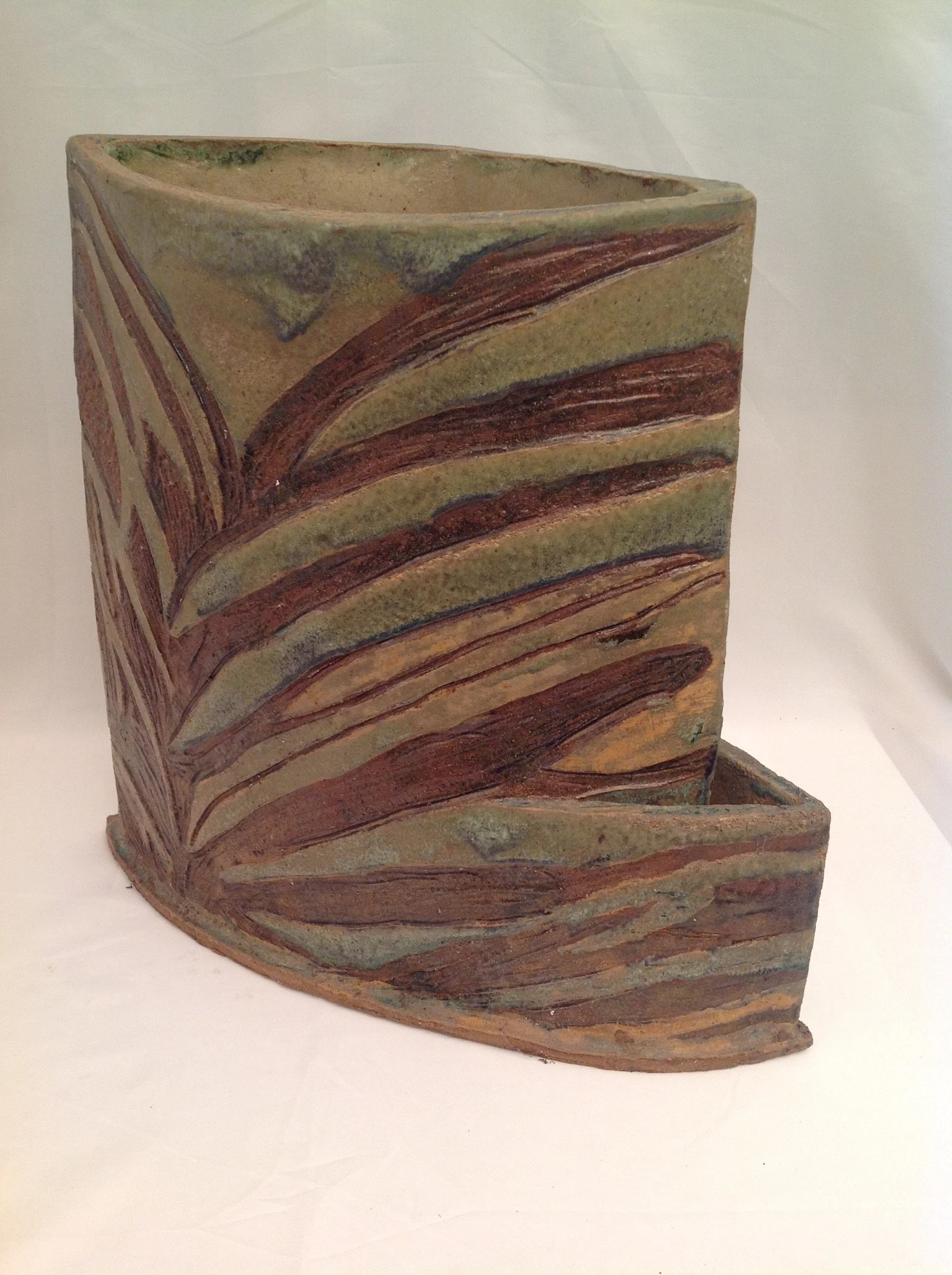 Tall stoneware planter with ribbed earthy texture and curved bands, made for aloe and cactus plants.