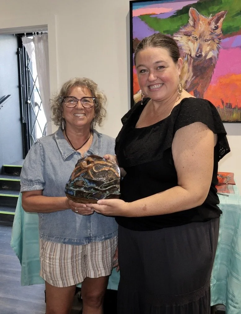 Artist Karen with patron who purchased work together in art studio.