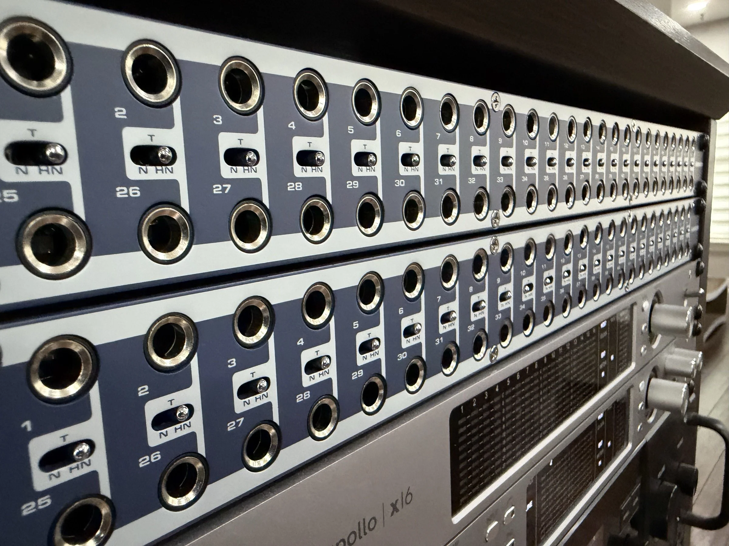 Close view of patchbay sockets and recording equipment in the Audio Sails studio.