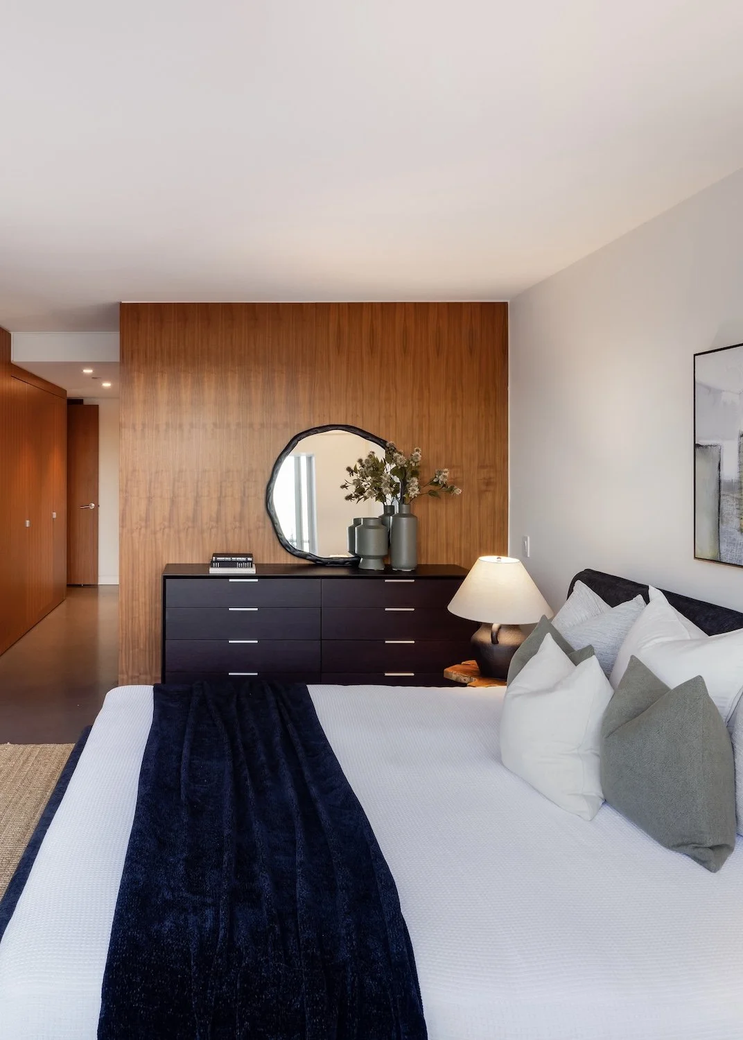 Neutral-toned primary bedroom in a Vancouver luxury townhouse with soft layered staging