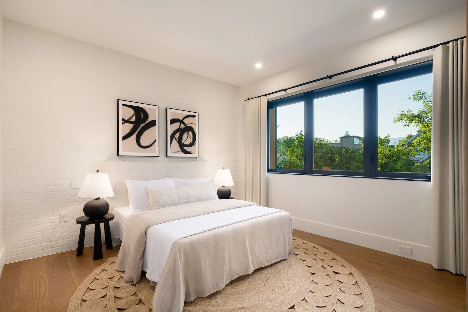Professionally staged primary bedroom in a luxury Point Grey duplex.