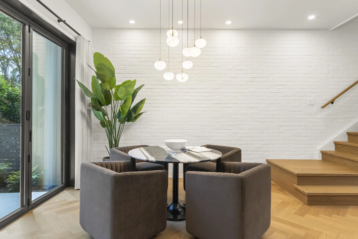 Dining table and contemporary chairs styled for a luxury Vancouver property.
