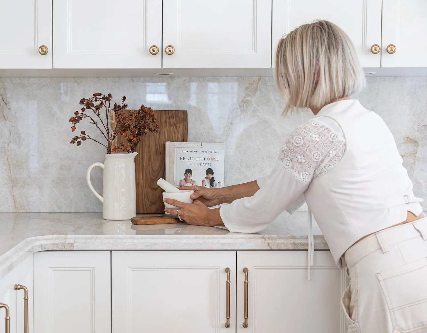 Interior designer Paula styling kitchen accessories in a luxury Cambie Village townhouse in Vancouver.