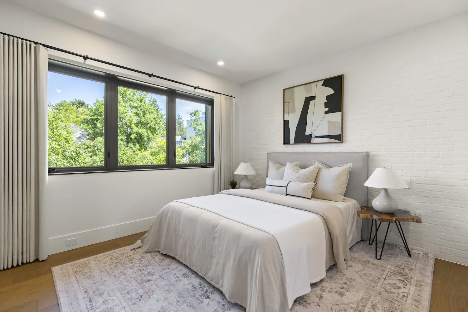 Professionally staged primary bedroom in a luxury Point Grey half duplex.