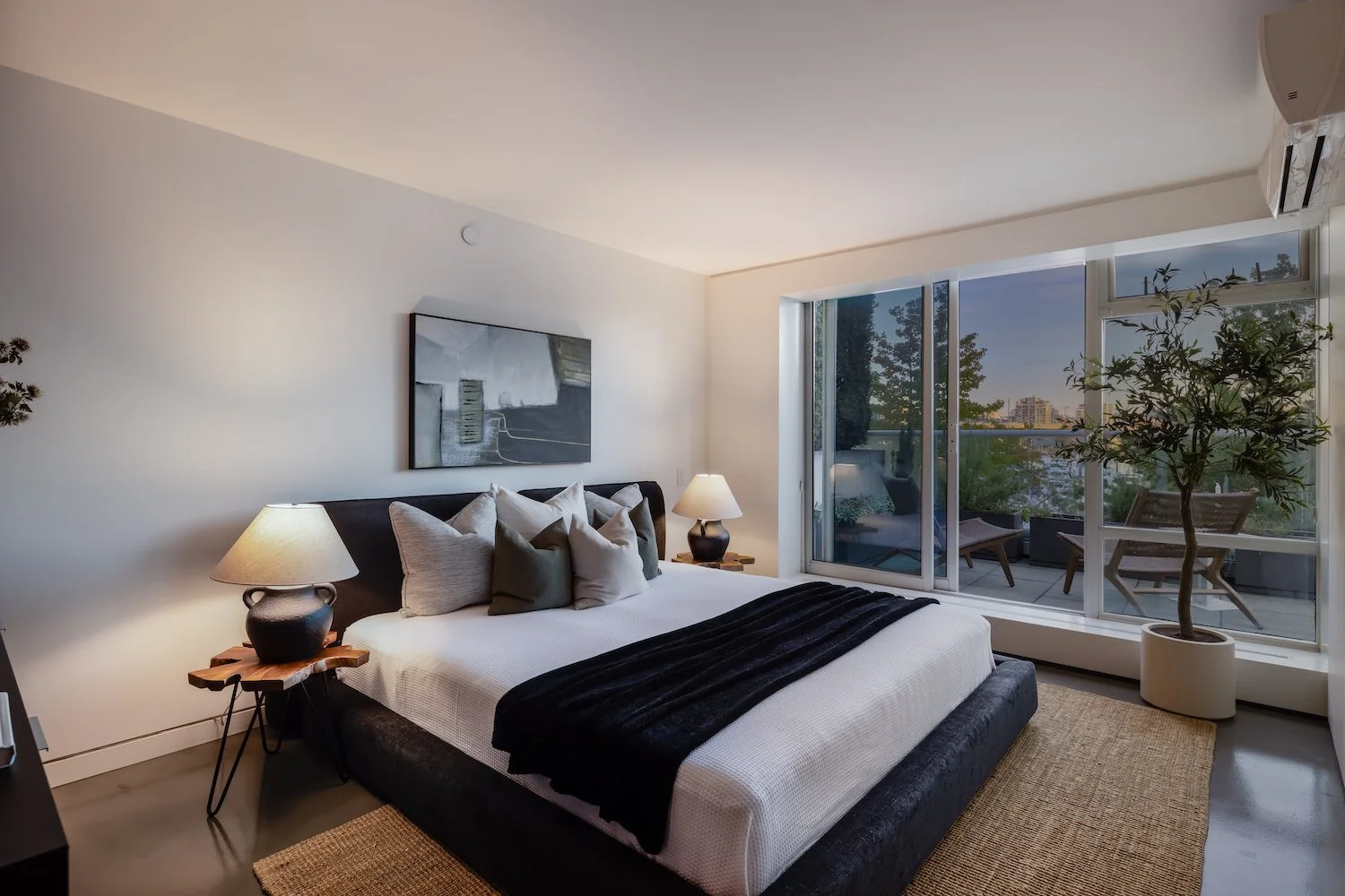 Light-filled primary bedroom in a Vancouver luxury townhouse with elegant and minimal staging