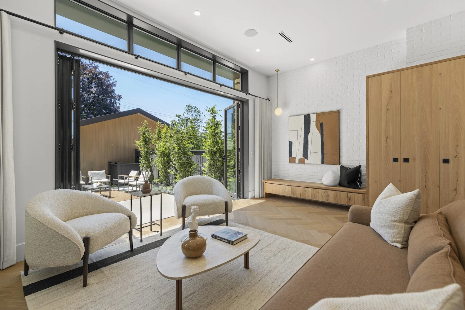 living room and adjacent patio area in a professionally staged Point Grey duplex.