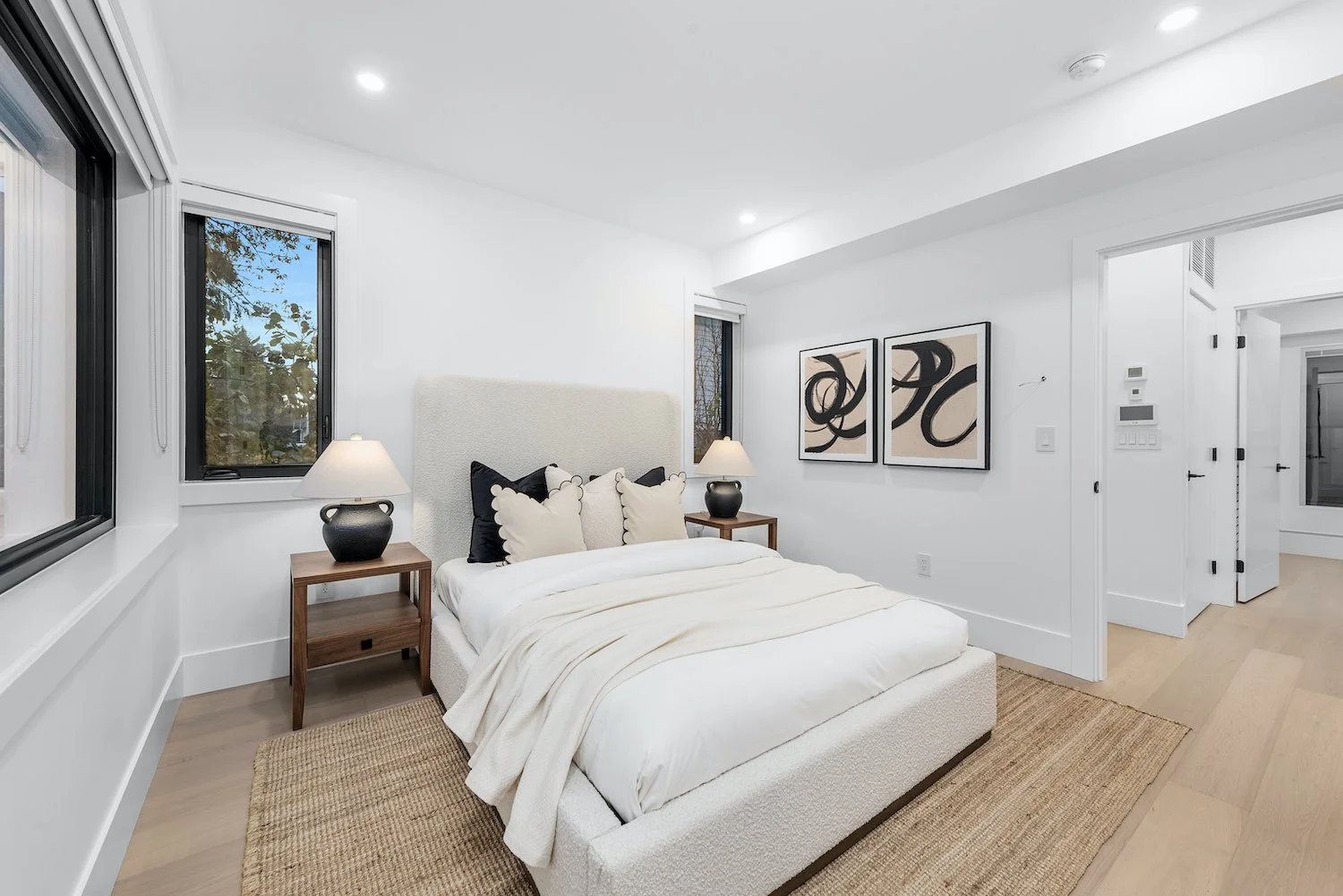 Calm primary bedroom in a Kitsilano duplex with neutral tones
