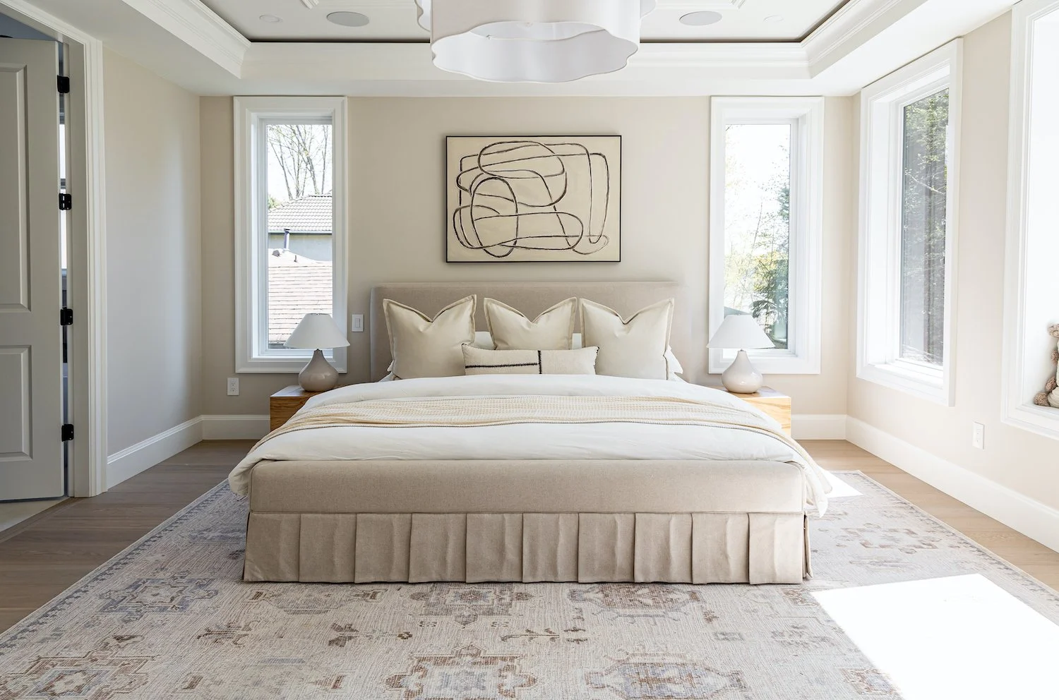 Neutral-toned primary bedroom in a Burnaby luxury home with soft, layered staging