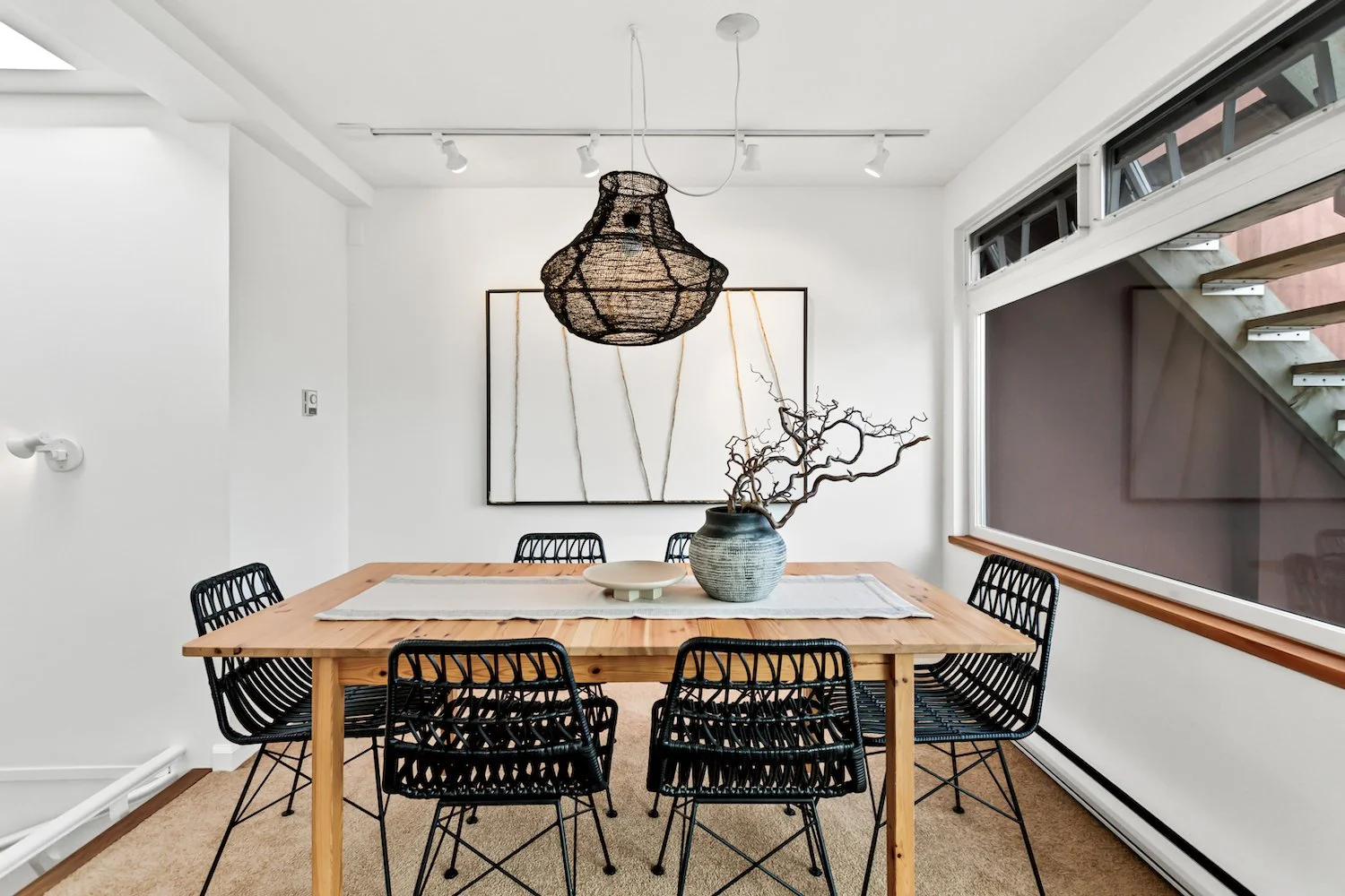 Modern dining area in a False Creek townhouse with minimalistic table styling