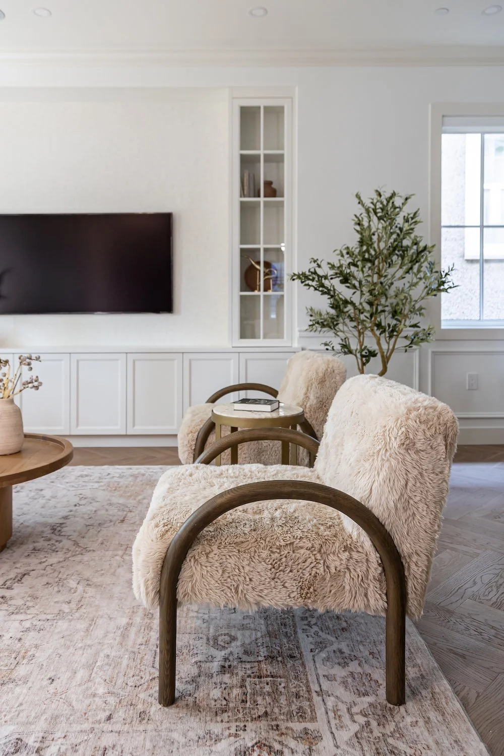Elegant living room with designer furniture and carefully layered textures in a Vancouver luxury townhouse.