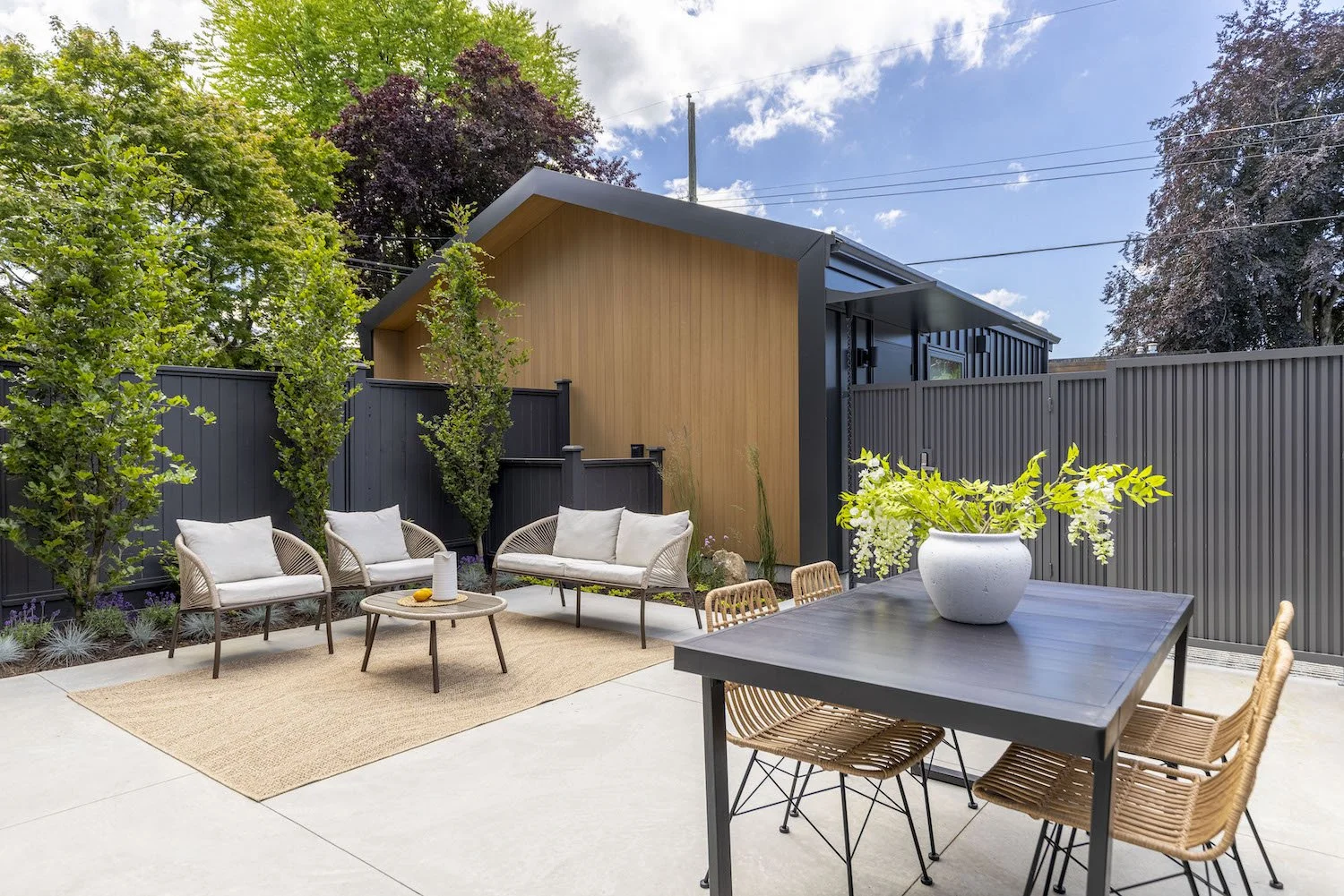 Outdoor lounge furniture arranged on the patio of a Point Grey property.