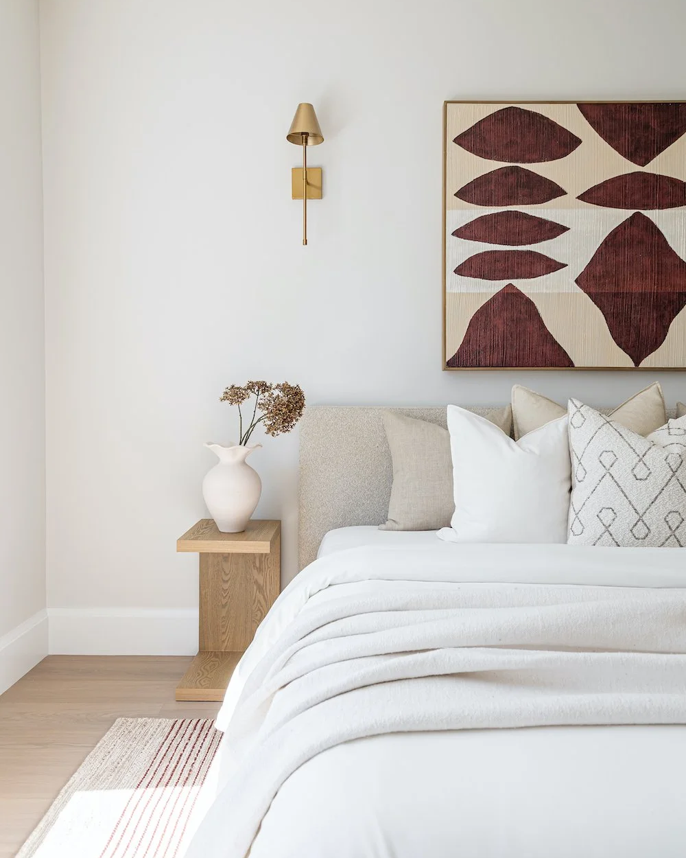 Staged bedroom with geometric artwork, linen bedding and warm neutral tones — vacant home staging Vancouver Lower Mainland by The Design Alchemist