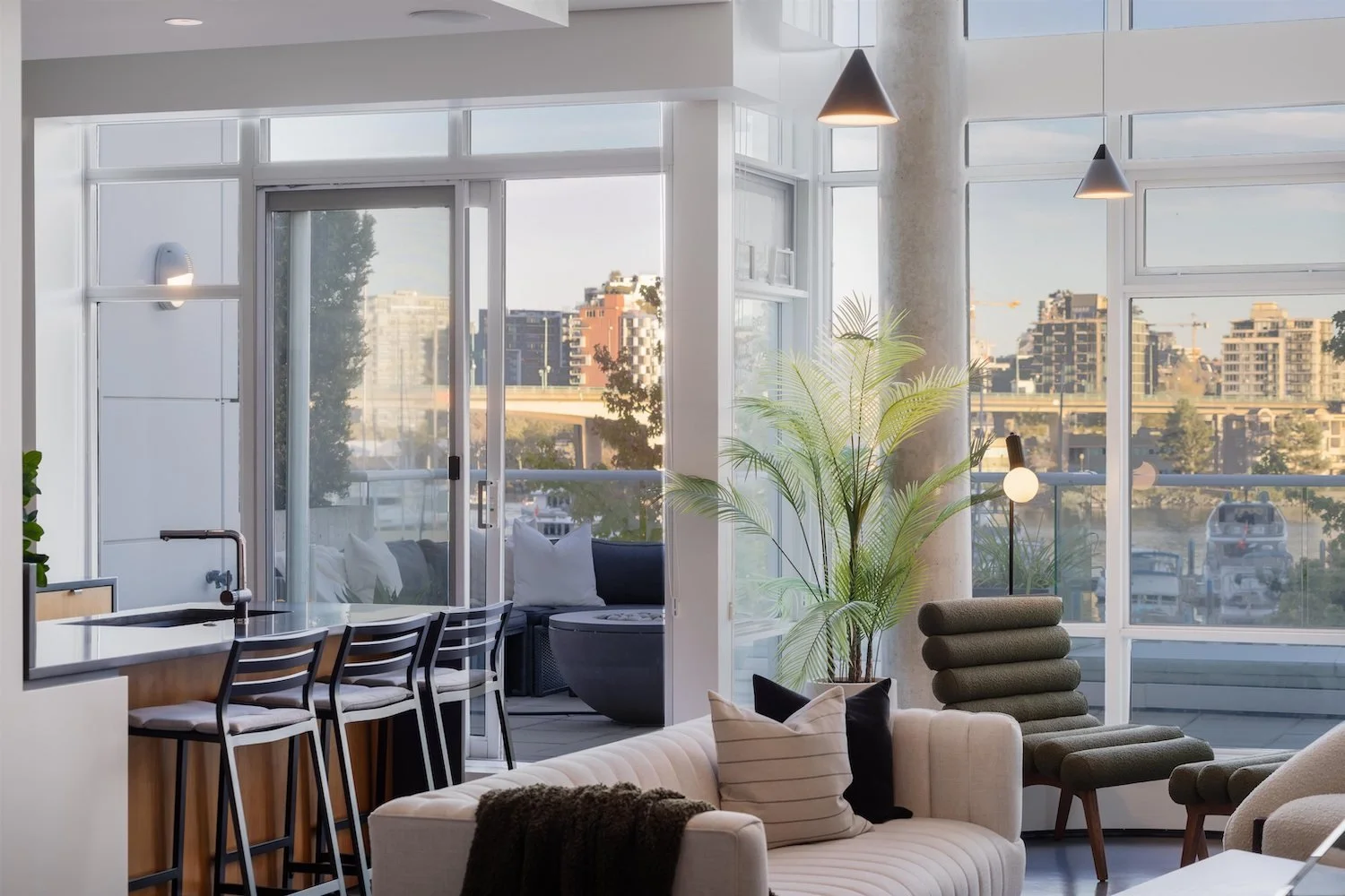 Professionally staged double-hight living room with marina views - luxury vacant home staging  in Yaletown Vancouver by The Design Alchemist