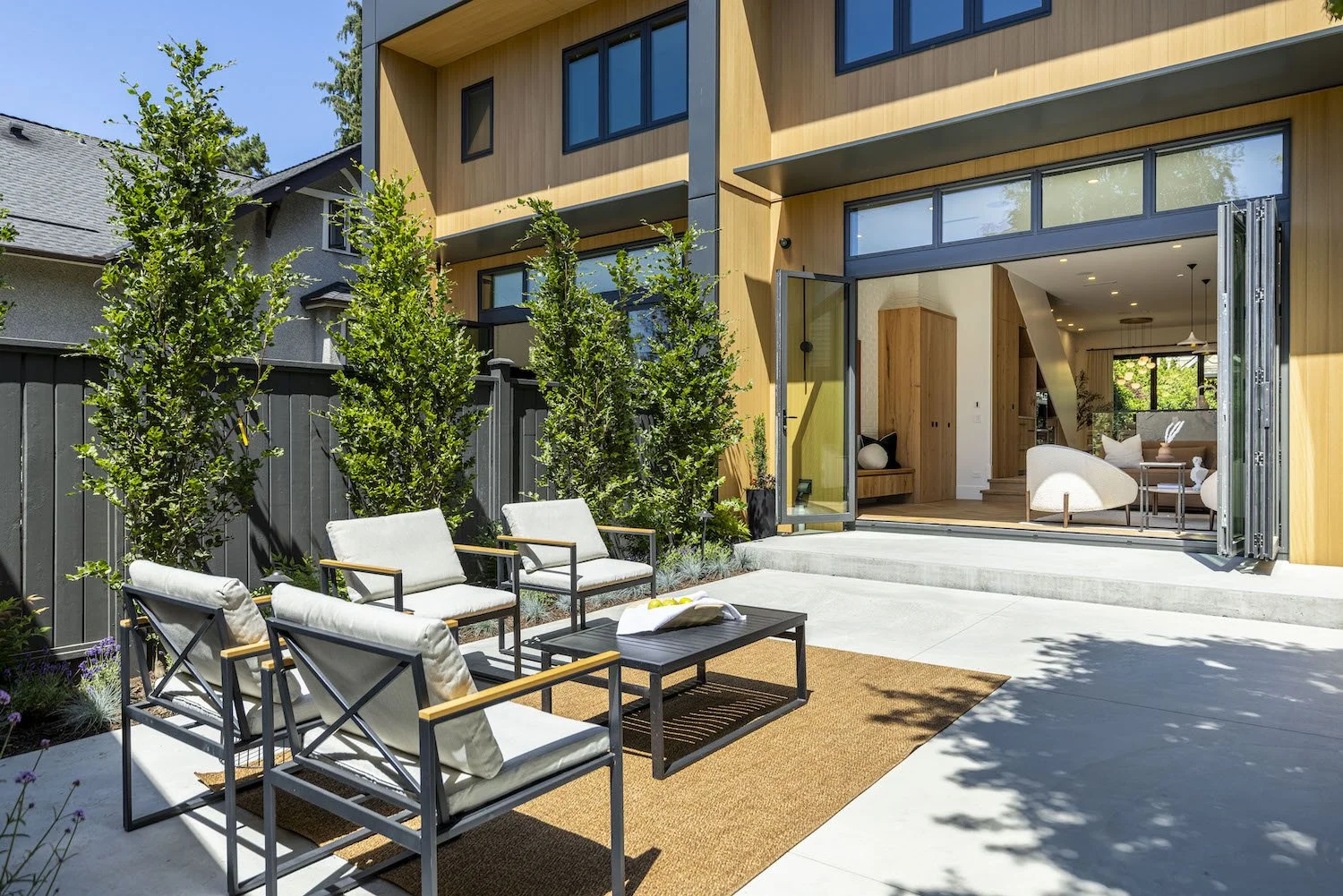 Outdoor lounge furniture arranged on the patio of a Point Grey property.