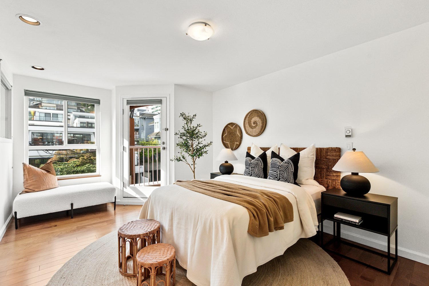 Calm and modern primary bedroom in a False Creek townhome with layered textures