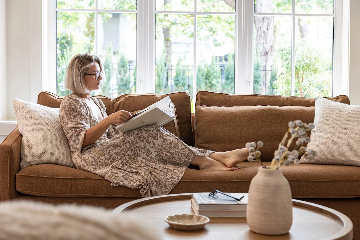 Interior designer Paula sitting in a professionally staged living room in a luxury Cambie Village townhouse.