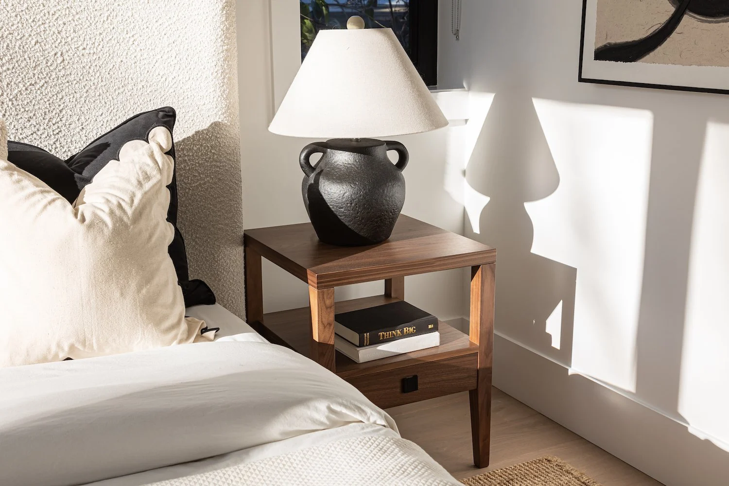 Soft and layered nightstand styling in a Kitsilano bedroom with neutral tones