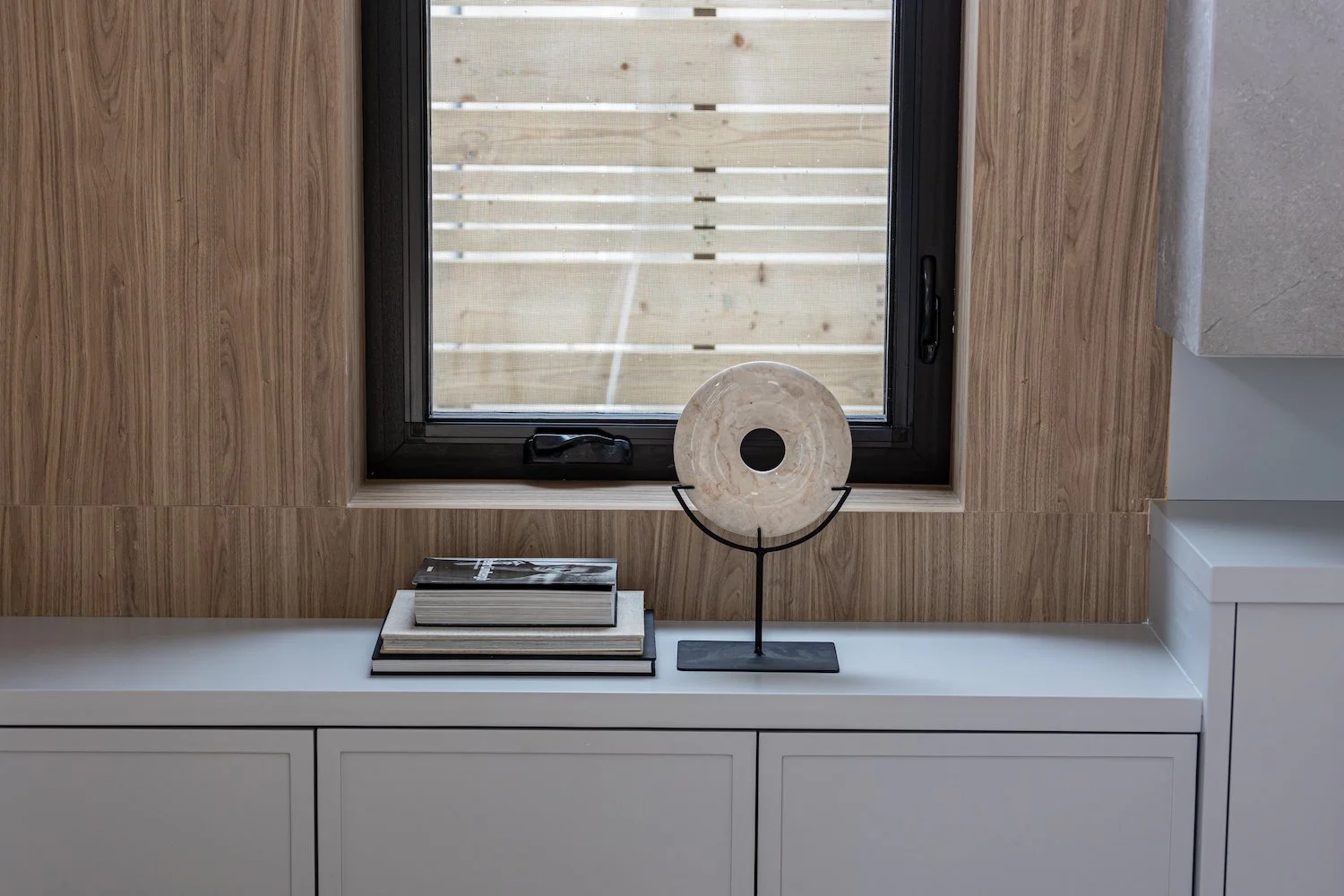 Styled console vignette with sculptural objects and warm walnut tones — professional home staging detail by The Design Alchemist
