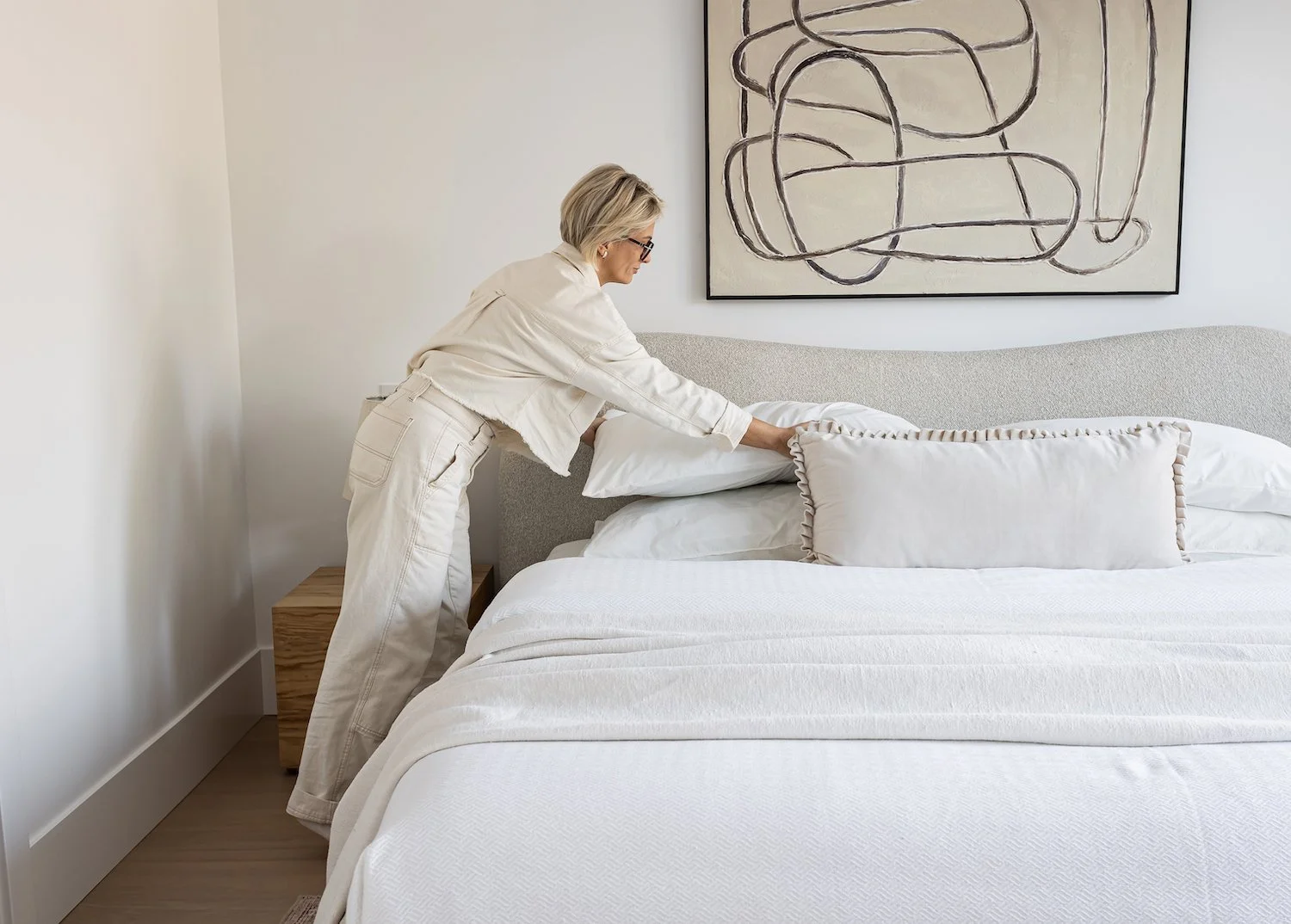 Layered bed styling in a Vancouver home with a warm and inviting feel