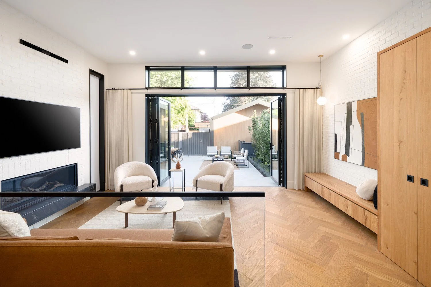 Open-plan living area and patio showcasing the interior styling of a luxury Vancouver duplex.