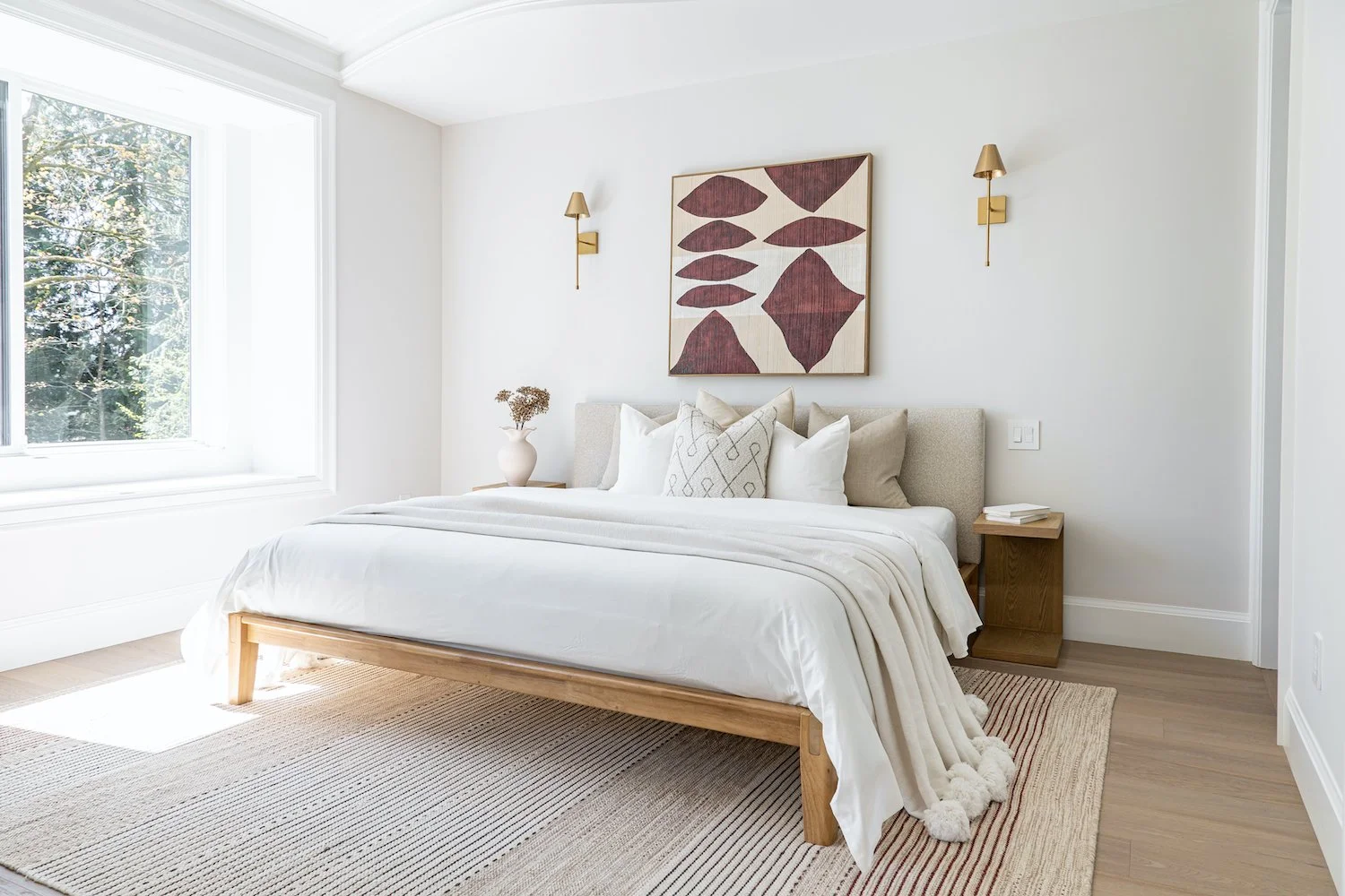 Light-filled secondary bedroom in a Burnaby luxury home with simple, modern staging