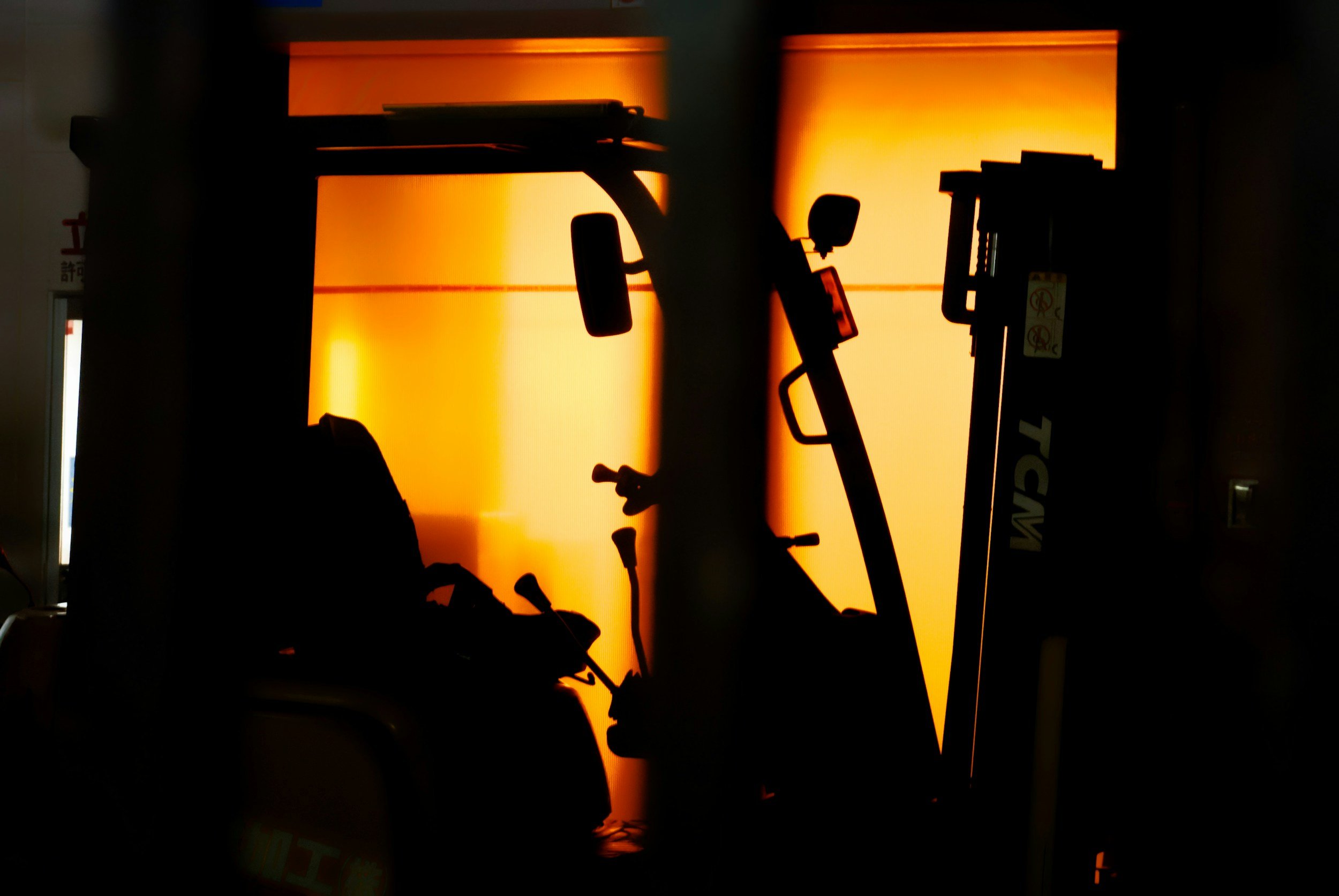 Forklift silhouette in a warehouse, symbolizing warehouse operations and logistics staff.
