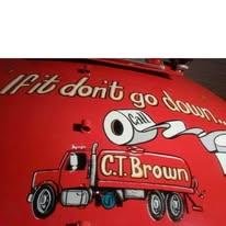 Red truck with cartoon character and text, part of a promotional or advertising display.