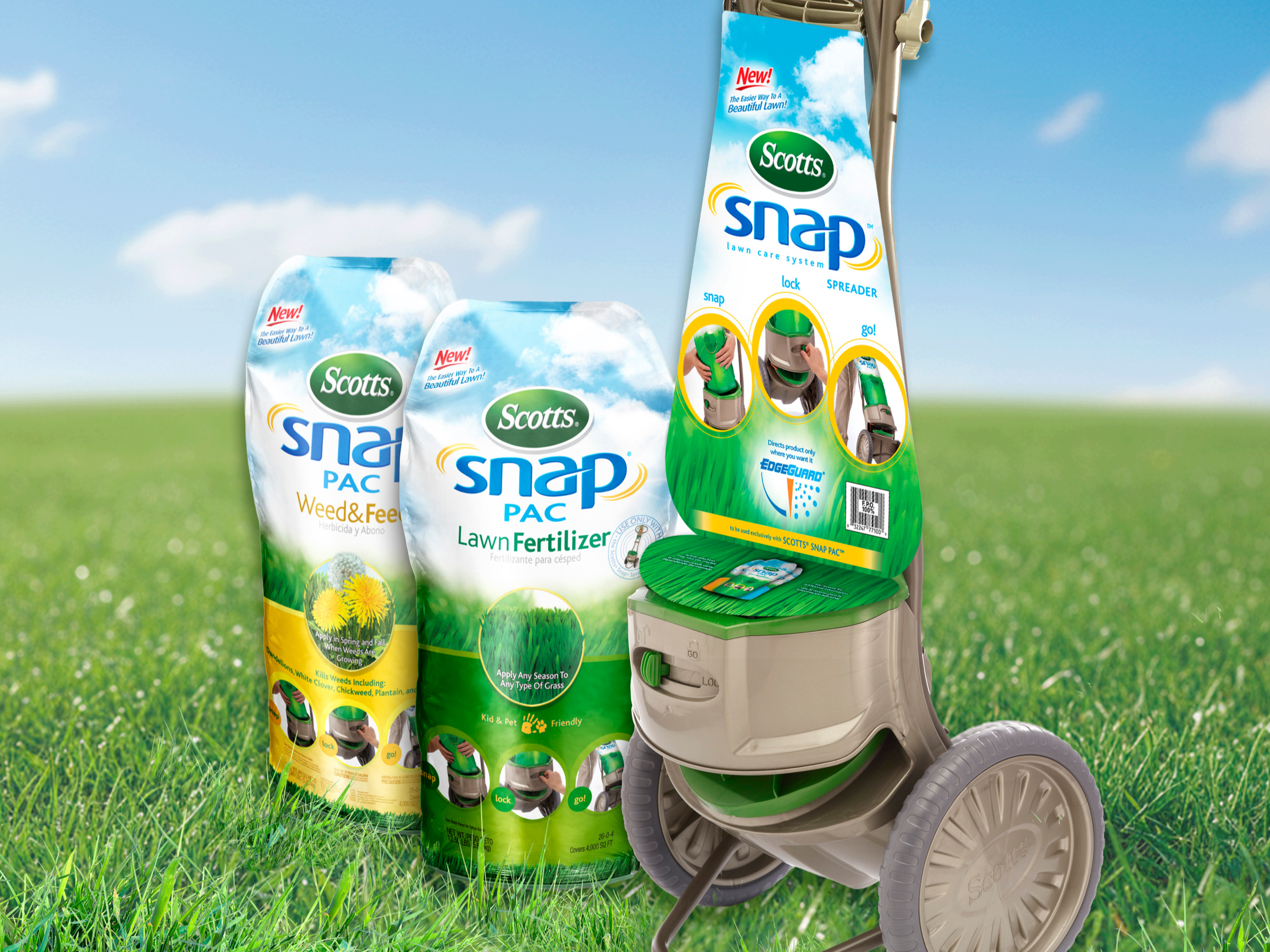 A lawn care system with Scotts Snap brand fertilizer and weed and feed products, a handheld sprayer with instructions for locking and going, placed on a bright green grassy field with a blue sky and white clouds in the background.