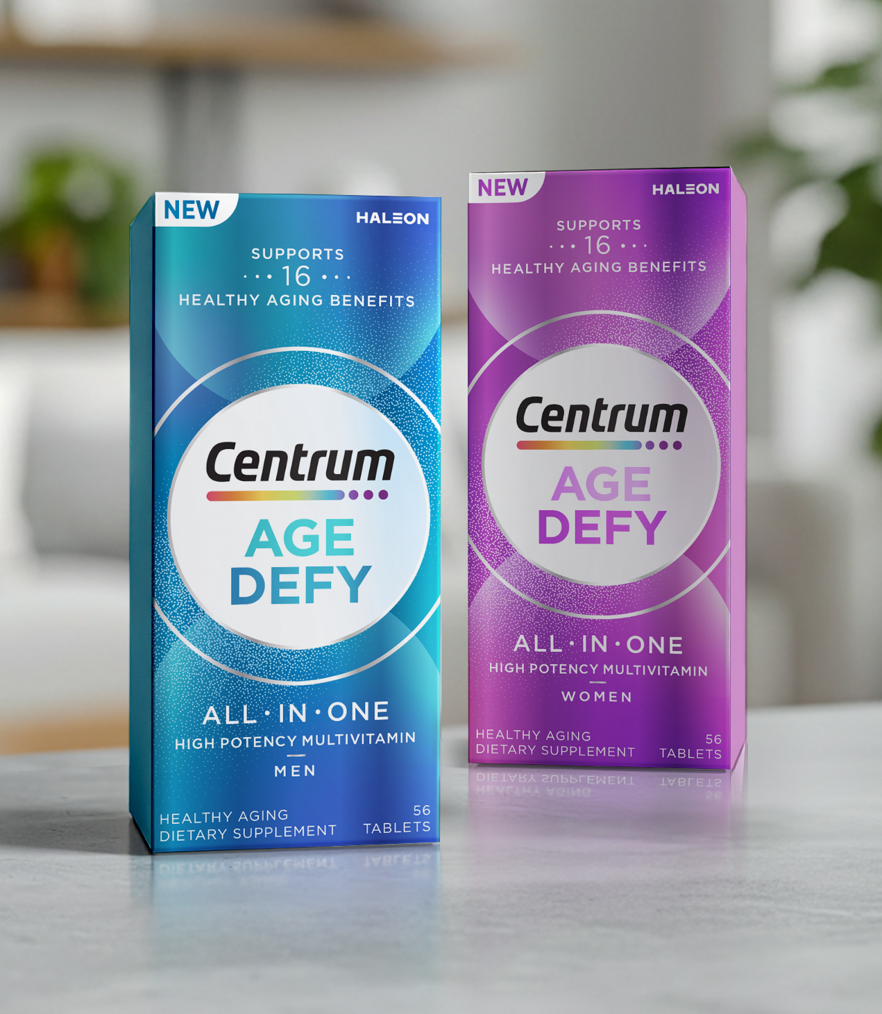 Two boxes of Centrum Age Defy dietary supplements, one for men and one for women, on a light-colored surface with a blurred background. The blue box is for men, and the purple box is for women.