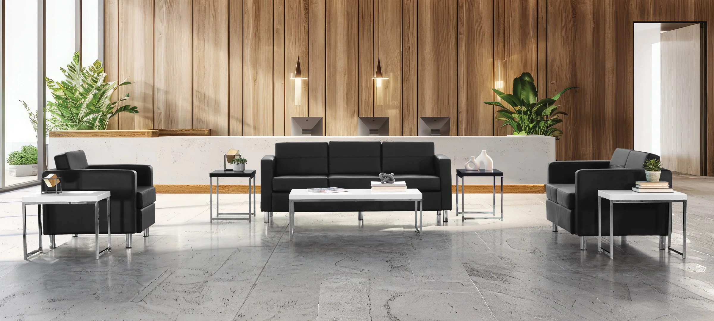 Modern lobby with three black sofas, glass-topped side tables, and a white coffee table. Wooden wall panels with three wall-mounted lamps and large green plants in planters in the background.